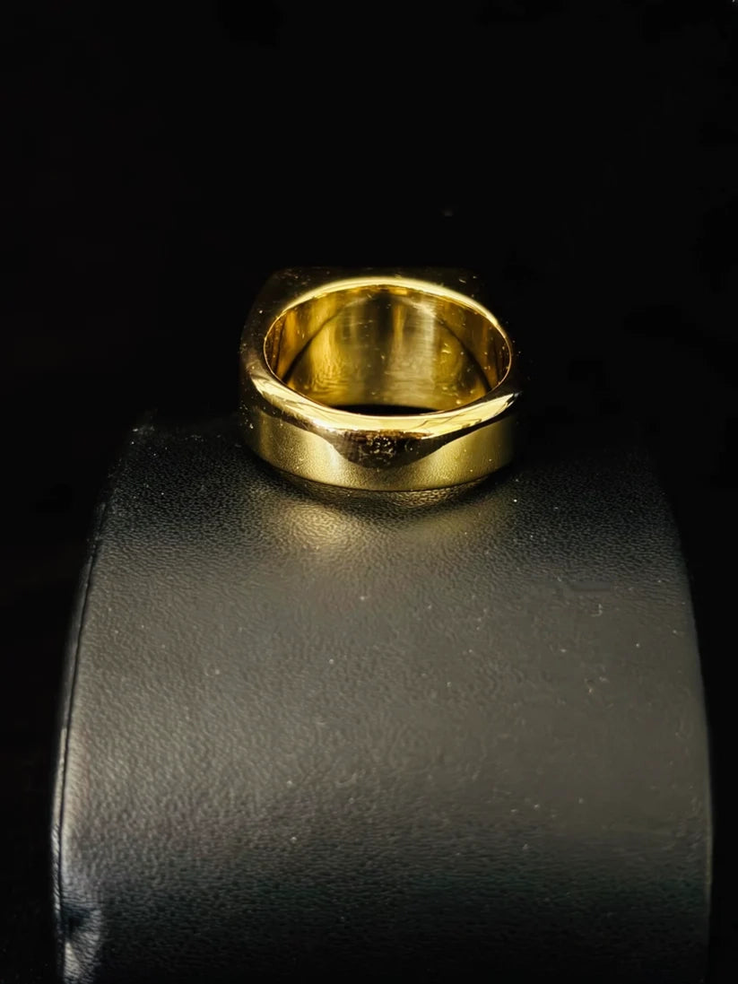 Gold plated square signet ring for men on a black background A back view 