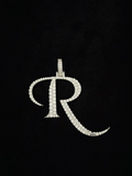 front view  Iced out cursive letter R diamond pendant charm in white gold.