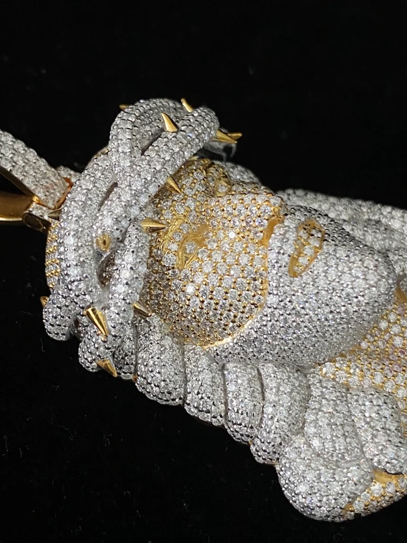 Two-tone 3D Jesus head pendant in yellow and white gold fully iced out with pave stones.