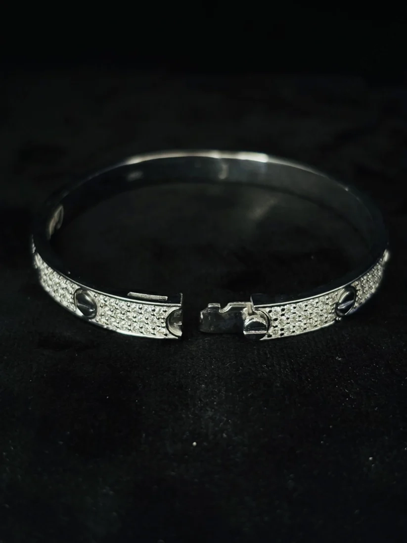 A back view Pave diamond silver Love bracelet with black ceramic screw motifs