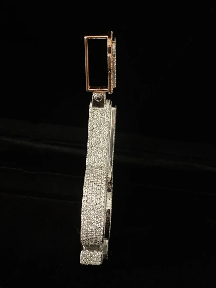 Side view of a custom diamond iced-out pendant with pave setting and rectangular bail
