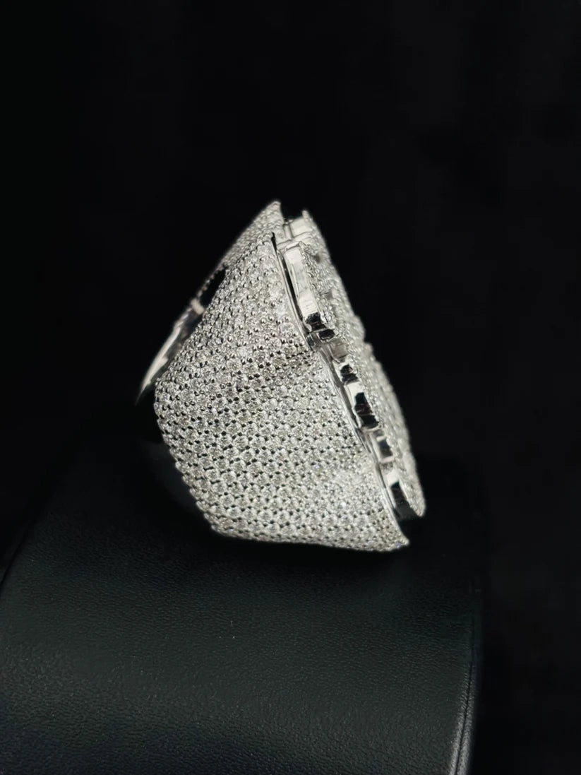 Side view of a chunky white gold statement ring fully iced out with micro-pave diamonds.