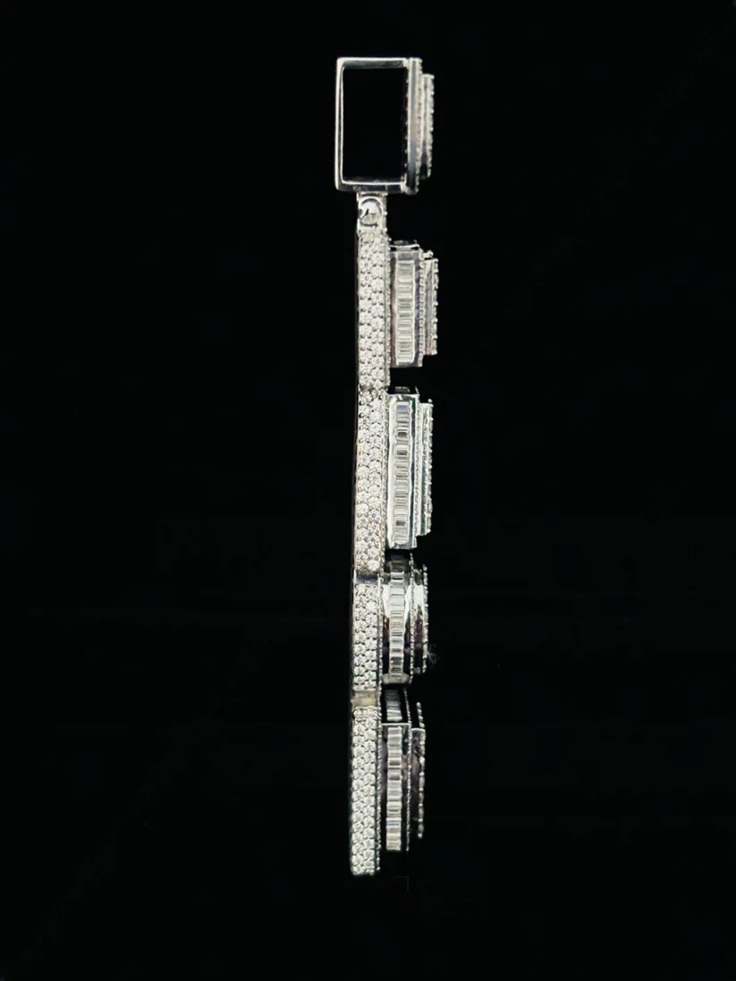 Side view of a custom vertical silver pendant with baguette and round cut moissanite stones 