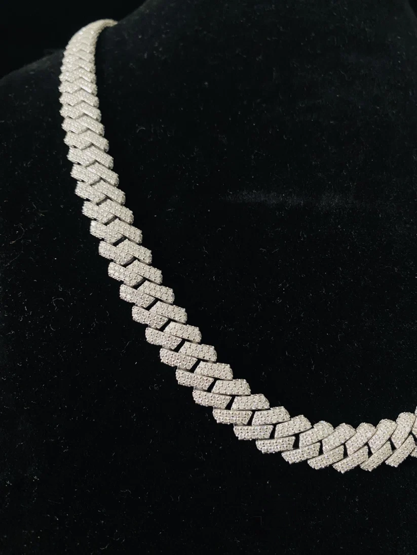 close up of a Iced-out silver baguette prong Cuban link chain necklace 