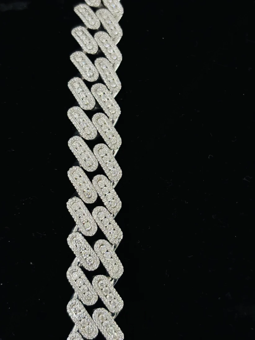 Silver diamond-encrusted baguette Cuban link chain close-up