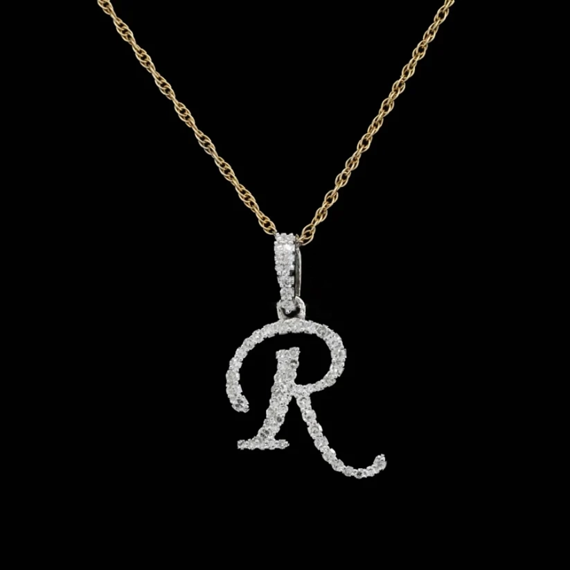 front view Diamond initial R pendant necklace in white gold on a gold rope chain