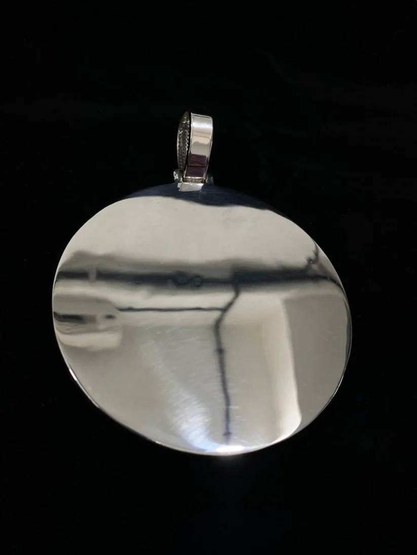 back view Polished sterling silver large round disc pendant necklace charm isolated on a black background