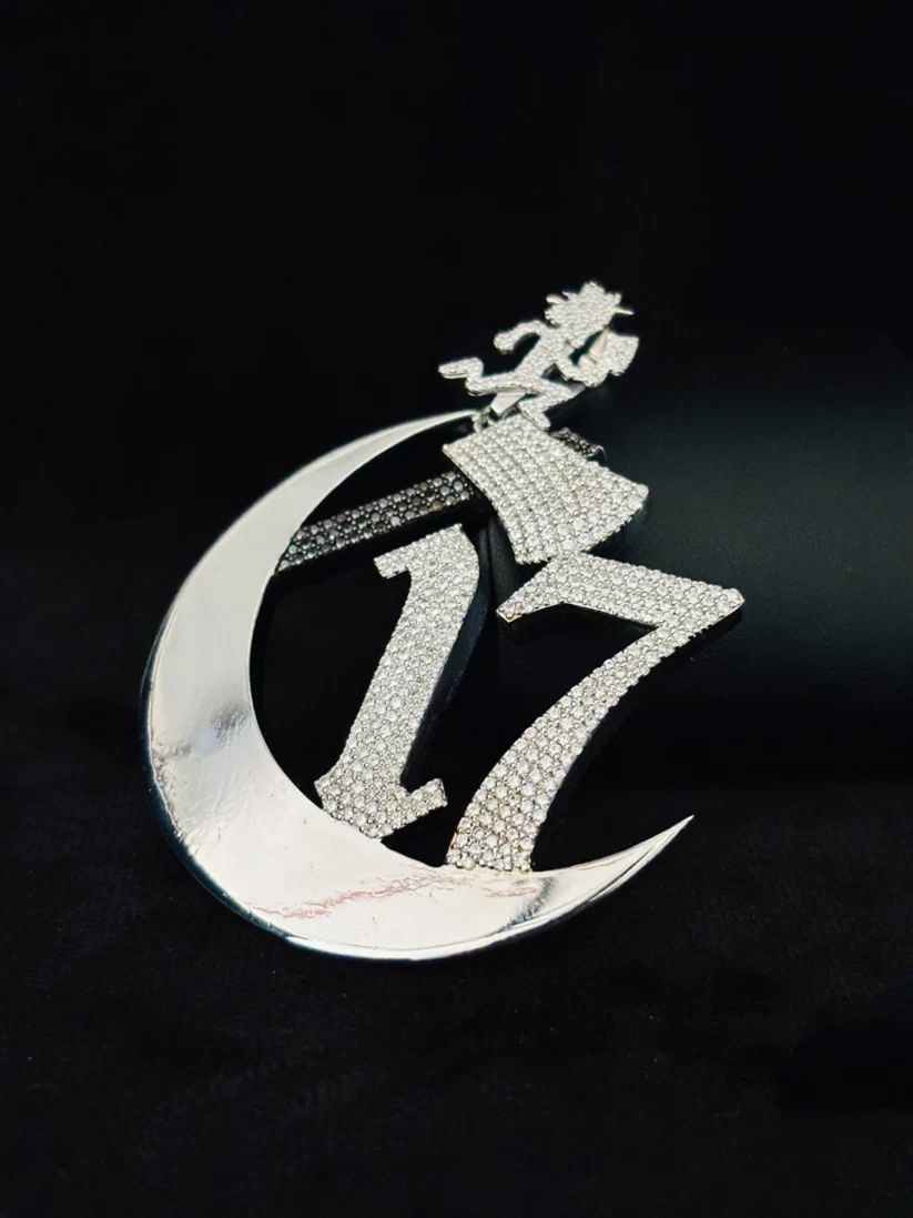 Silver iced out Chapter 17 crescent moon pendant with Moissanite diamonds and Hatchetman figure.
