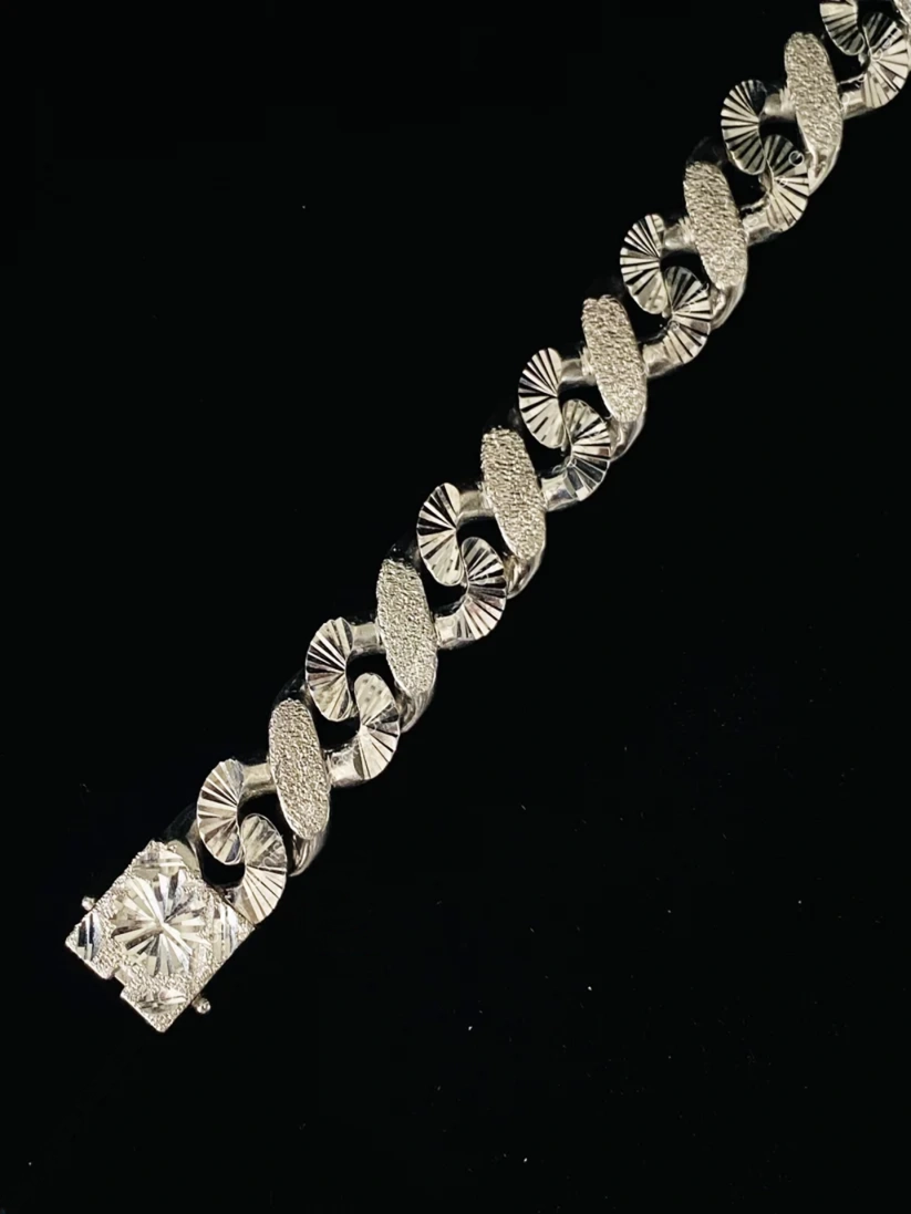 Sterling silver XO link bracelet with textured finish and decorative clasp