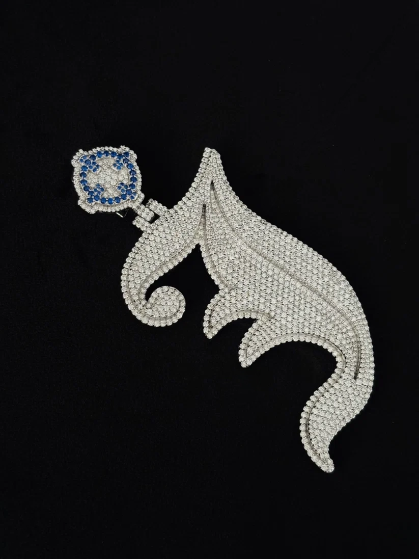 Iced-out sterling silver initial J pendant necklace with white diamonds and blue sapphire bail