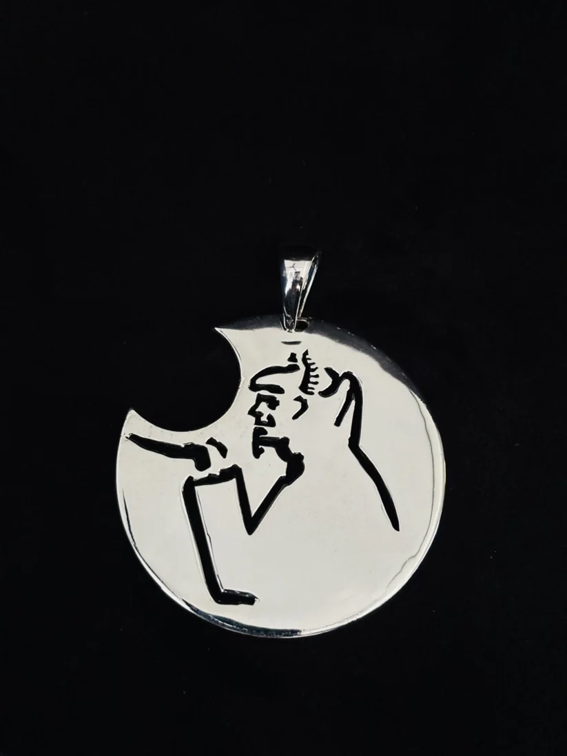 A silver pendant featuring a minimalist black line art sketch of a person, shown against a solid black background.