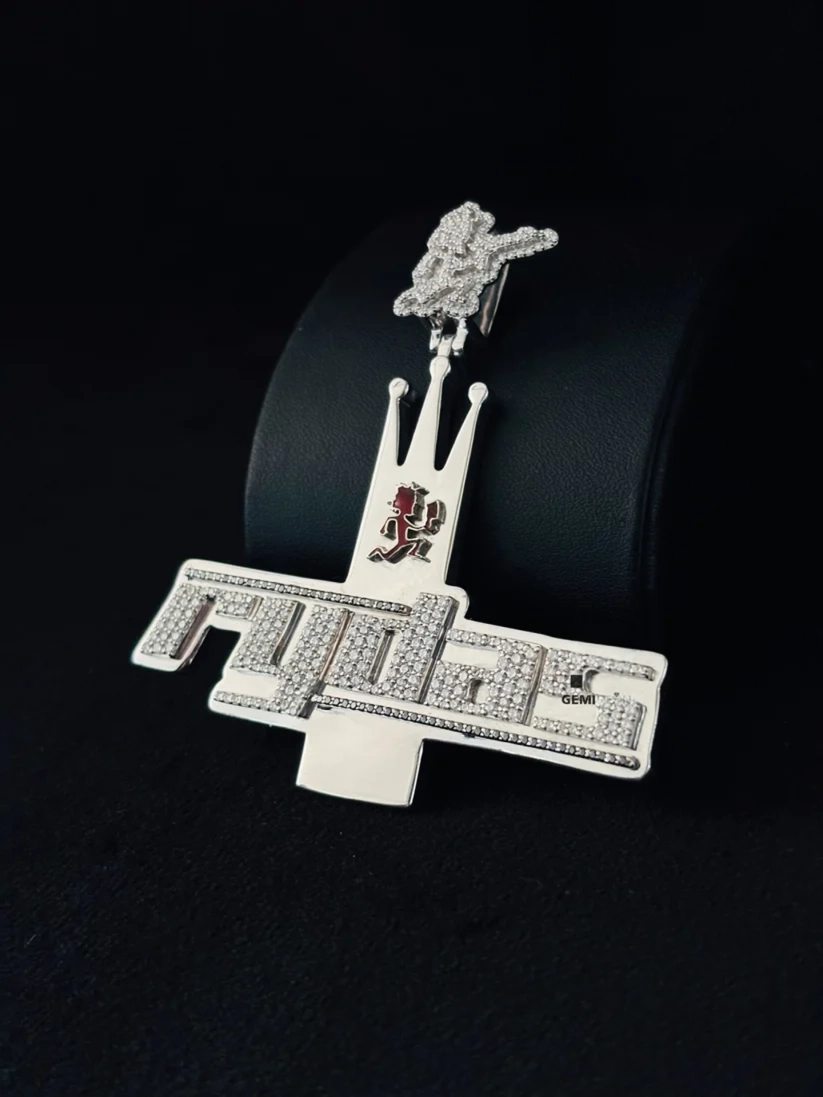 Luxury iced-out silver custom chain pendant featuring the Rydas logo and crown design against a black background.