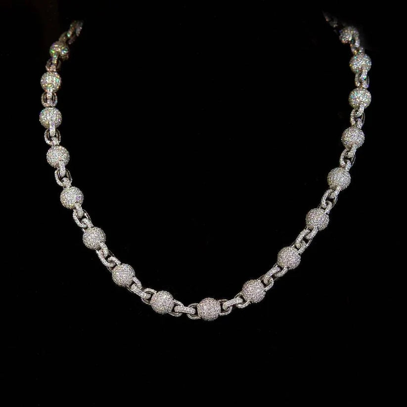 Silver or white gold necklace featuring textured round beads encrusted with small diamonds connected by interlocking links
