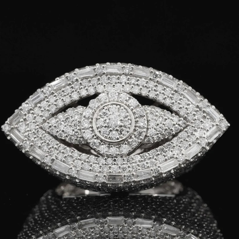 Diamond evil eye ring in white gold featuring a pavé center cluster and baguette border.