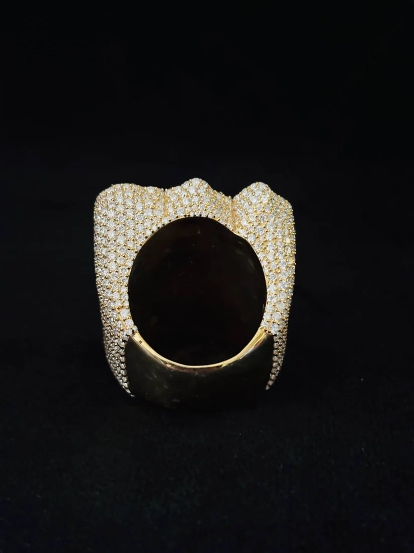 A Back view wide gold plated ring featuring a surrounded by a textured, diamond-paved bored
