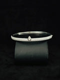 A Close-up view Silver pave diamond cuff bracelet with a central teardrop diamond accent