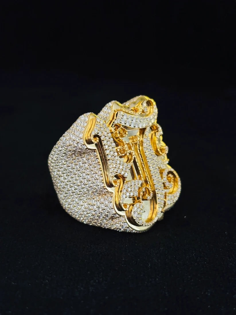 A side view Custom iced-out initial statement ring in two-tone 