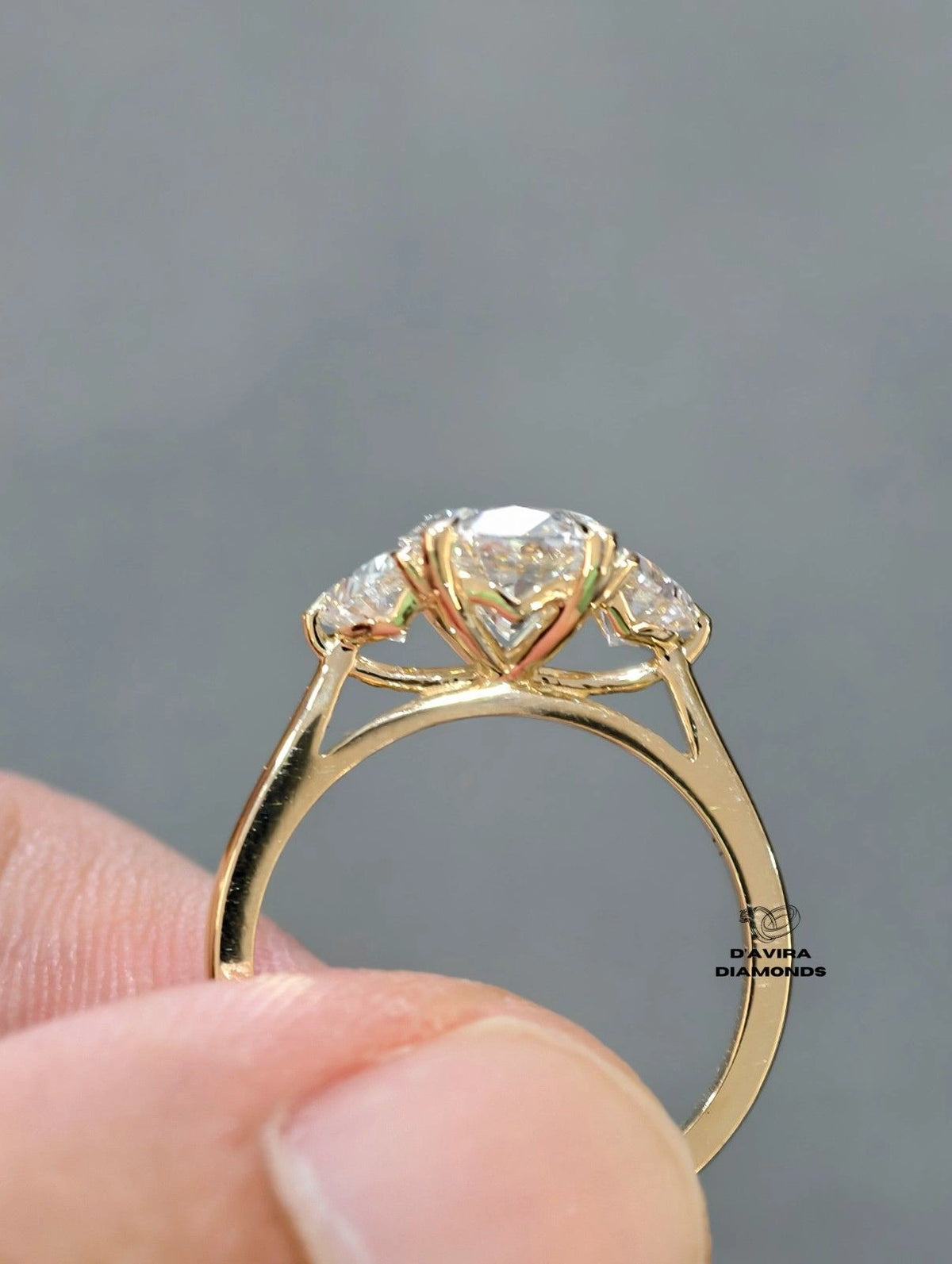 oval cut stone ring with a yellow gold band