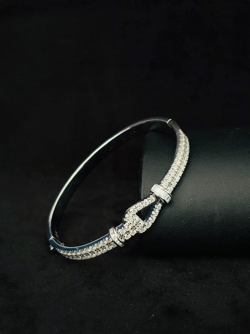 Silver pave diamond horseshoe buckle bangle bracelet on a black display background