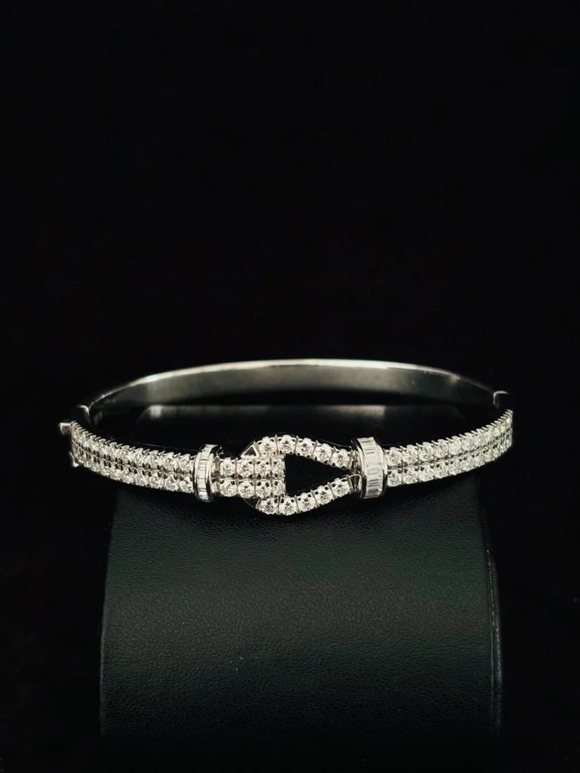 Silver diamond buckle bangle bracelet featuring a double row of pave diamonds