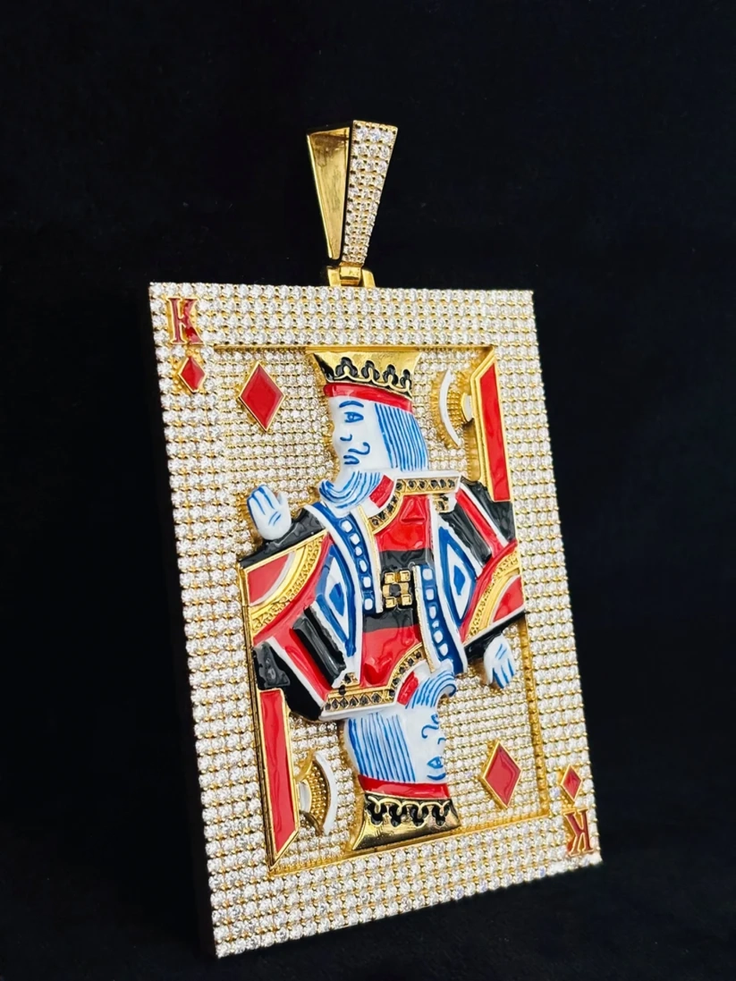 Iced out King of Diamonds playing card pendant in gold with diamonds and enamel details.