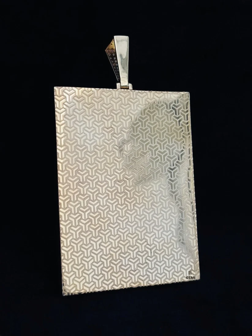 back view silver dog tag style pendant featuring custom geometric line art engraving.