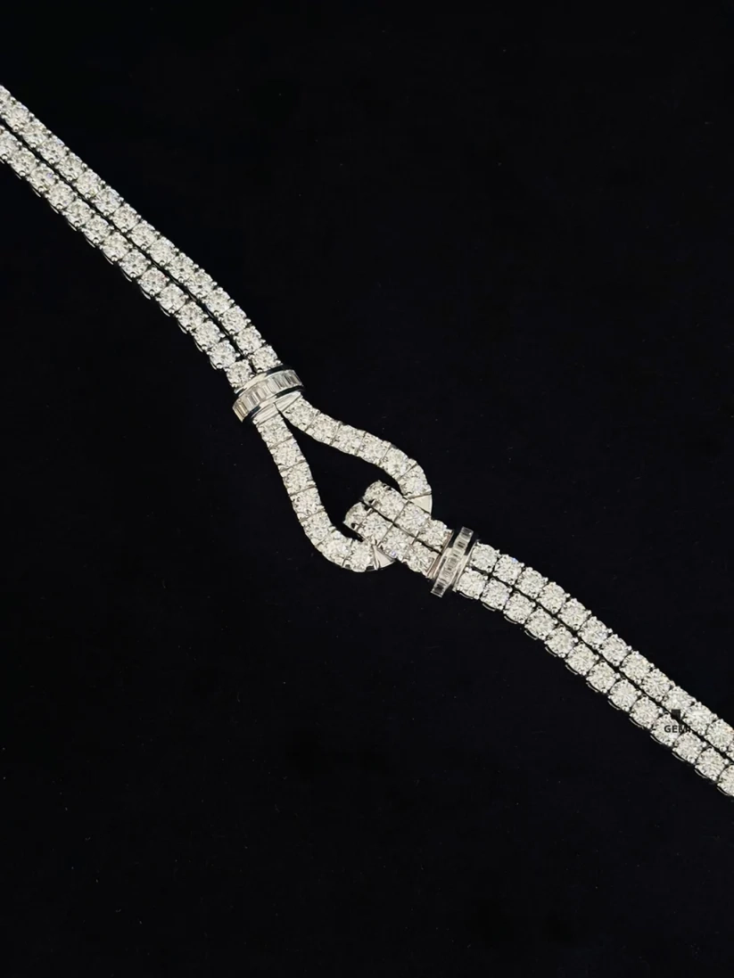 Double strand diamond tennis bracelet with a paved horseshoe buckle clasp 