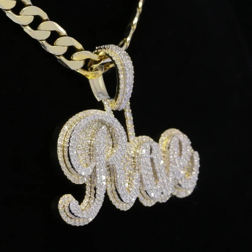 Gold and diamond script name pendant necklace spelling "Rae