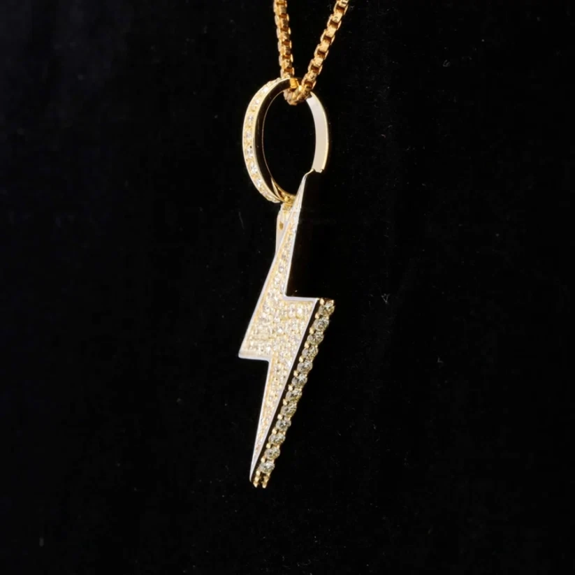 Gold lightning bolt pendant with pavé diamonds.