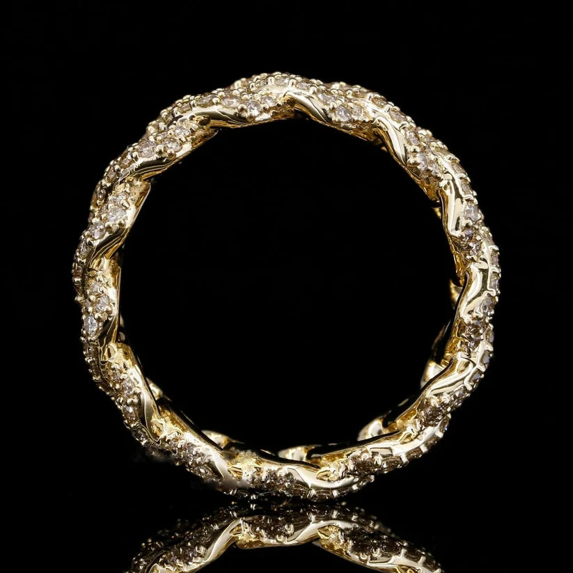 Close up of a yellow gold plated rope style eternity ring set with small diamonds