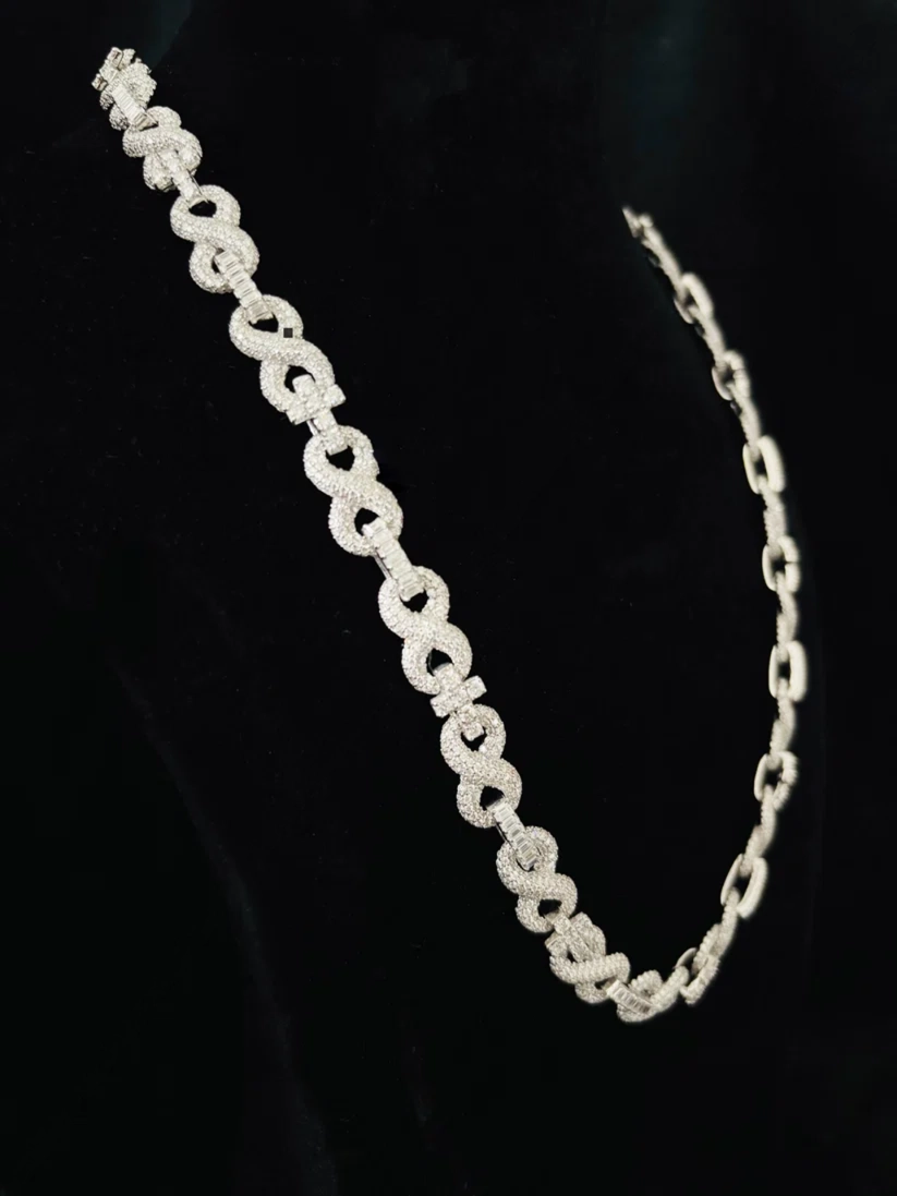 Silver infinity symbol link necklace laid flat, intricate link detail and clasp craftsmanship
