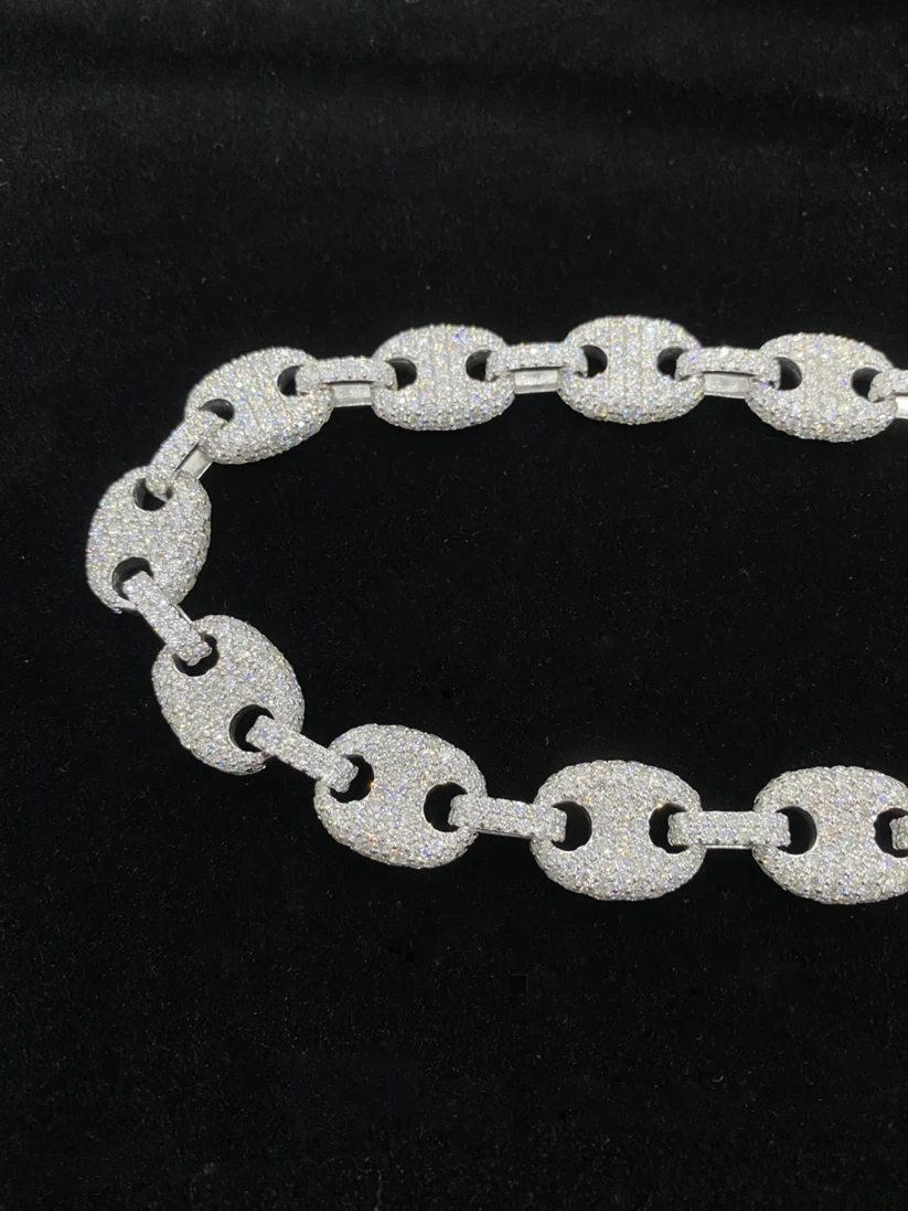 close up of a Silver Gucci link chain necklace iced out with pave diamonds