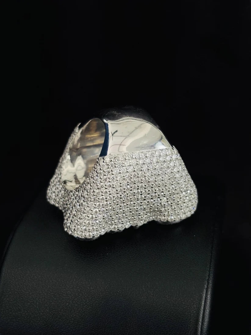A chunky silver ring featuring a textured, diamond-like pavé band