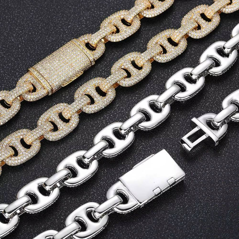 Gold and silver iced out mariner link chains with diamond box clasps.