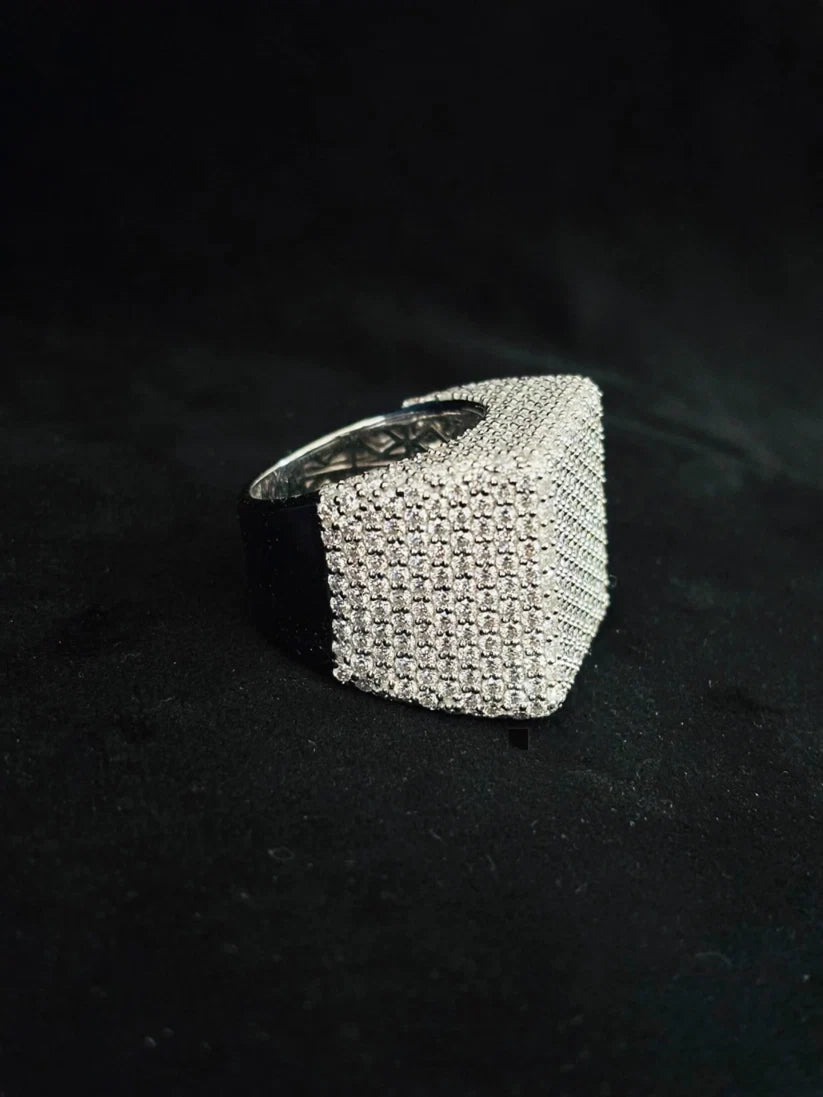 Close-up side view of a chunky iced-out square statement ring for men 
