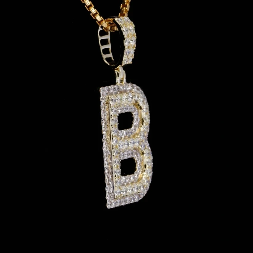 Iced out 14k gold initial B pendant necklace with pave diamonds on a gold chain.