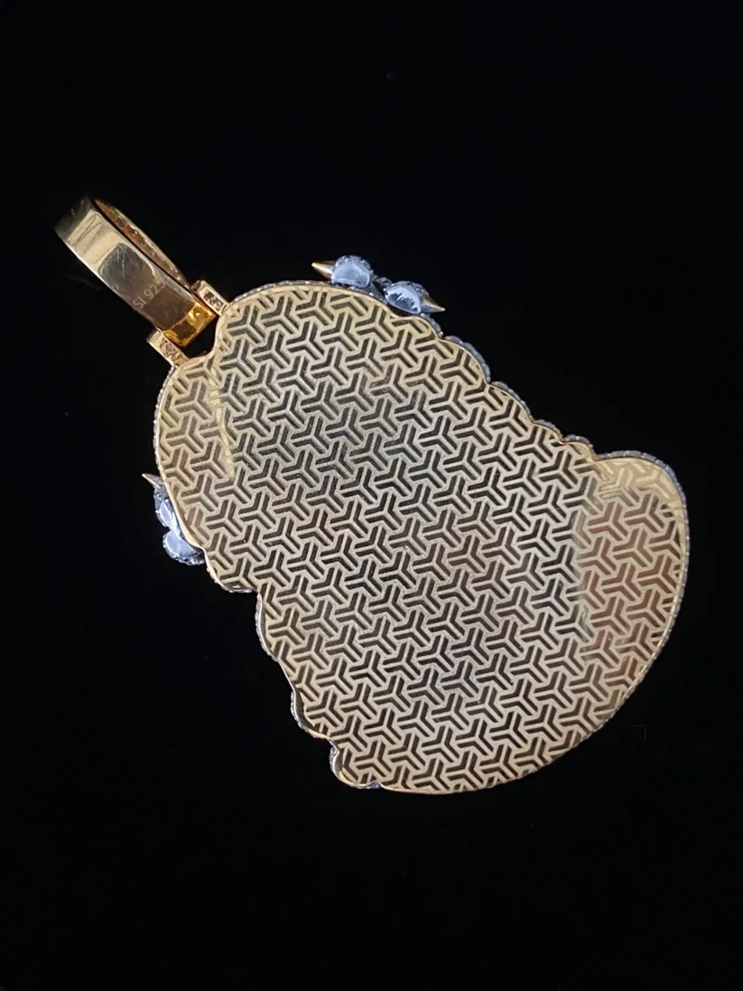 Back of gold and diamond iced-out Buddha pendant featuring a textured geometric pattern lattice