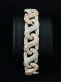 A wide, chunky snake-link bracelet in pave-set metal, displayed on a black circular stand