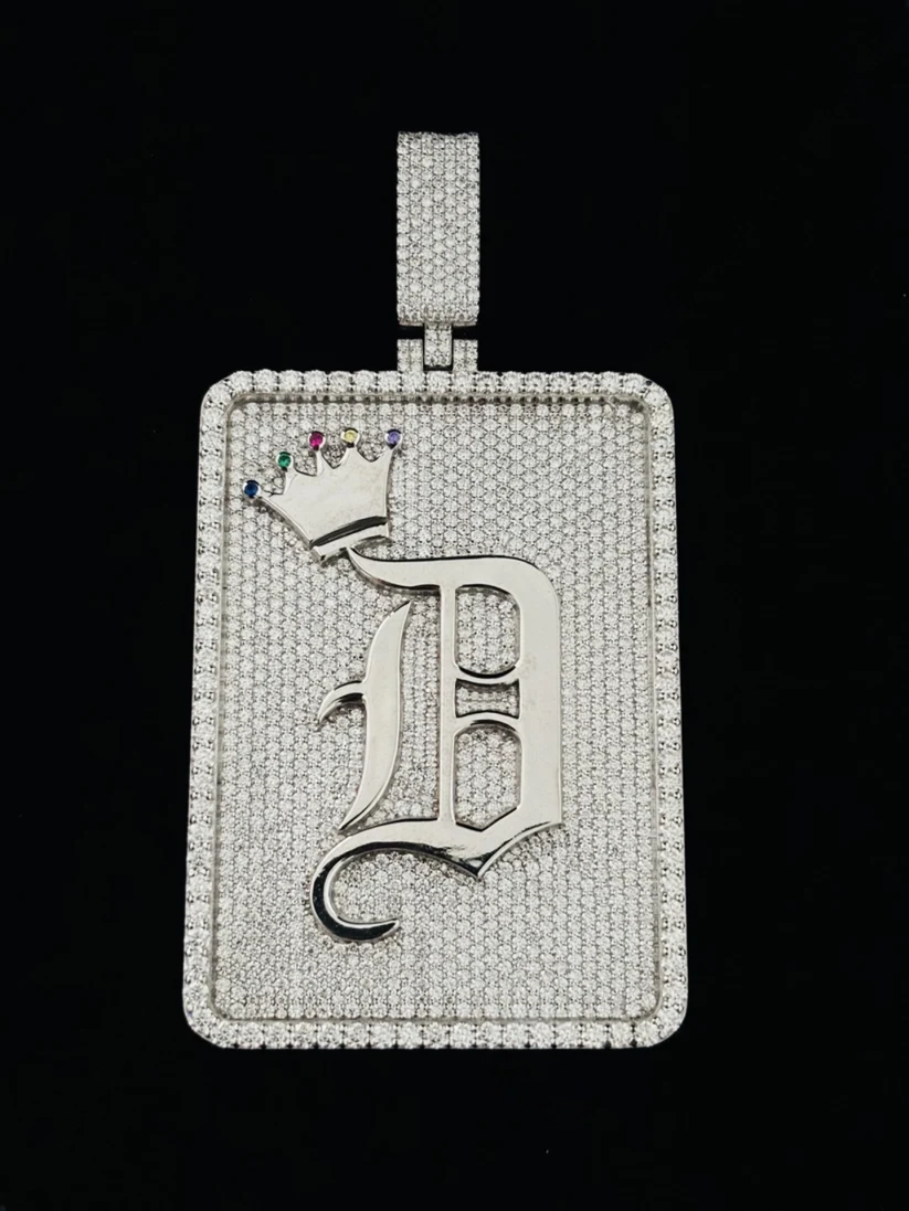 front view Custom iced out Old English letter D pendant with diamond pavé rectangular plate and gemstone crown.