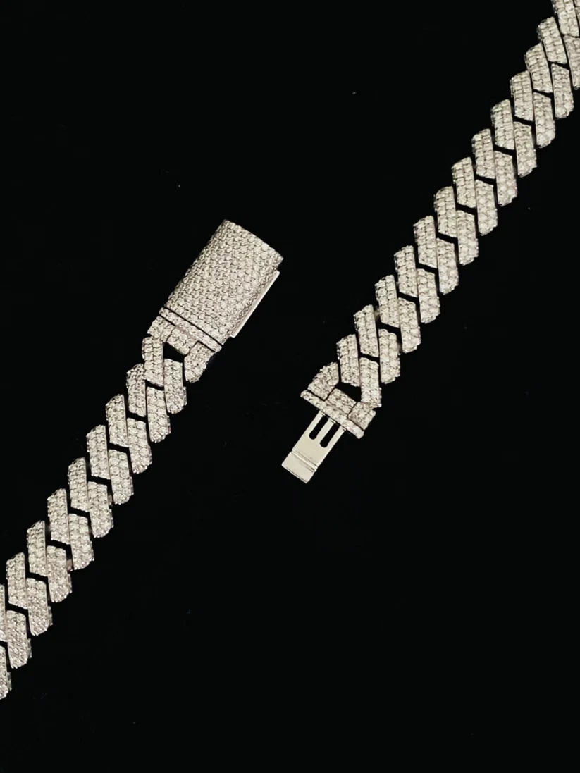 Iced-out silver baguette diamond Cuban link chain with a diamond encrusted clasp close up