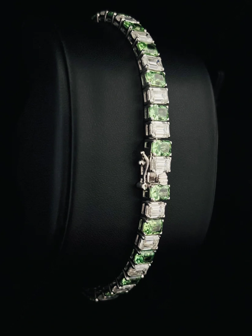 Emerald cut green tourmaline and diamond tennis bracelet in silver