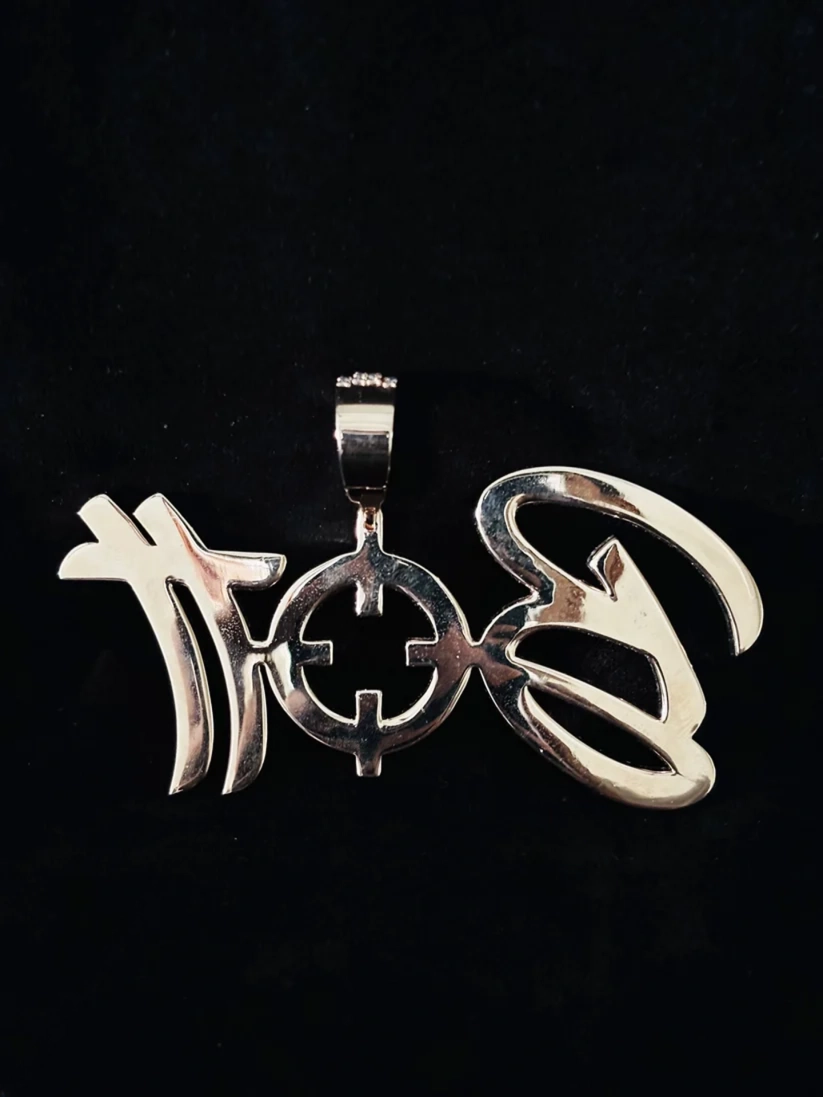 Custom silver hip hop pendant featuring stylized script lettering and a central crosshair target design