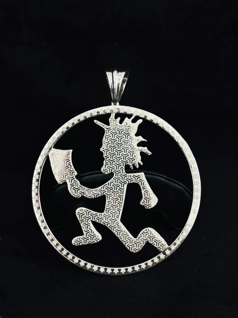 A Back view sterling silver pendant featuring a circular frame with a small beaded border and a central Kachepa figure