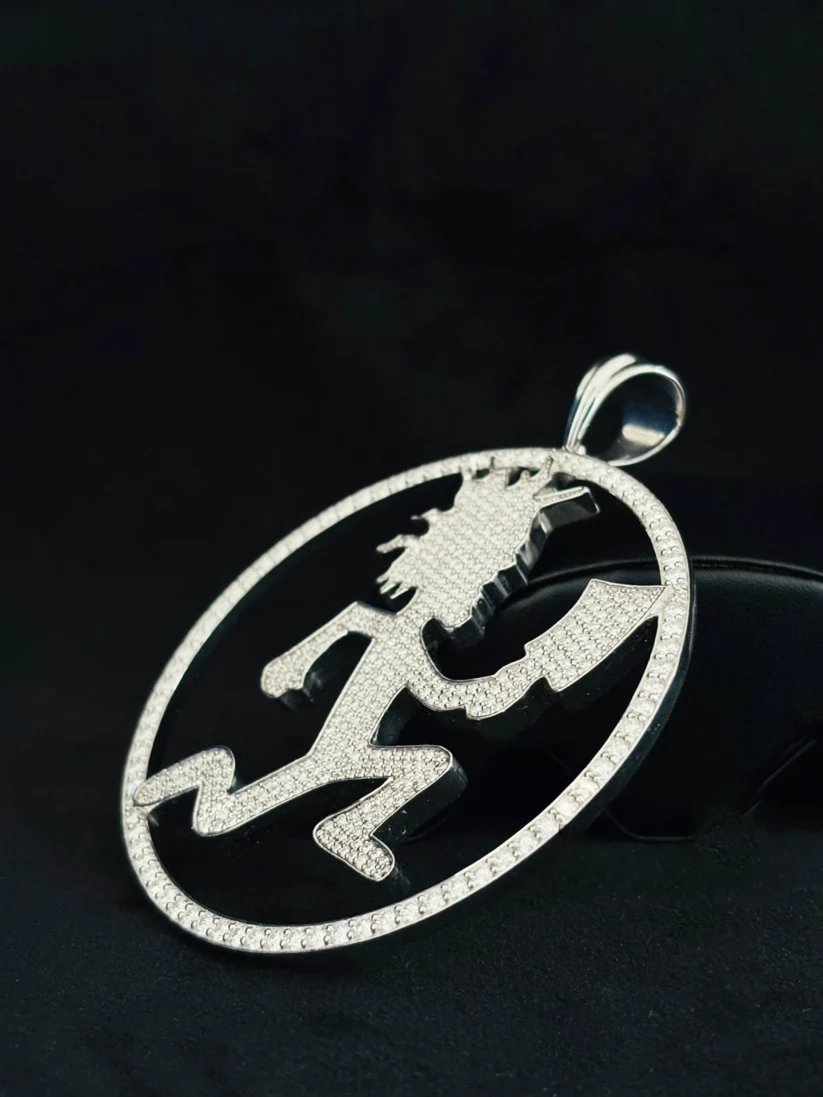 A Side view silver pendant necklace featuring a stylized running figure design paved Necklace for men