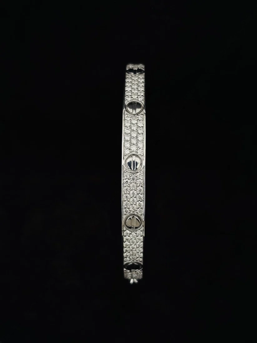 Close-up of a paved diamond love style oval cuff bracelet