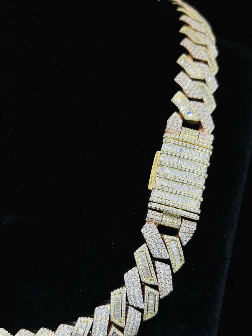 Iced out geometric chevron link chain necklace in gold and silver with a diamond-encrusted box clasp