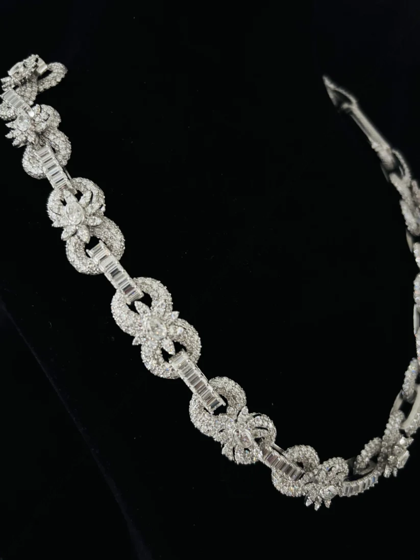 side view of the Diamond infinity link bracelet in white gold or platinum with baguette accent bars
