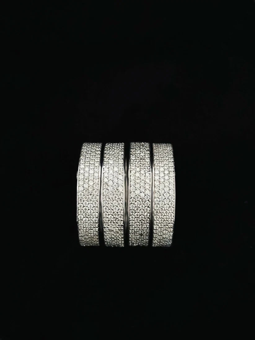 A close-up view Bold silver eternity band rings stacked together for a modern statement jewelry look