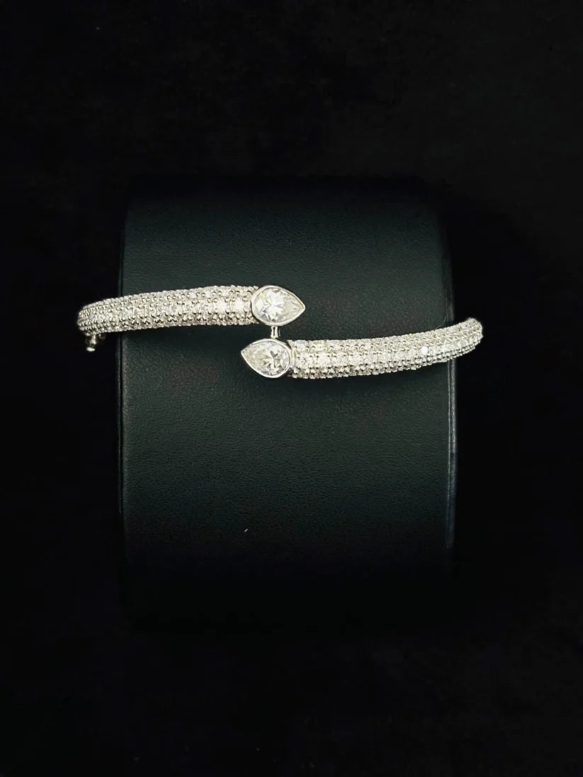 A Close-up view of the Pave diamond bypass bangle bracelet with pear-shaped diamond