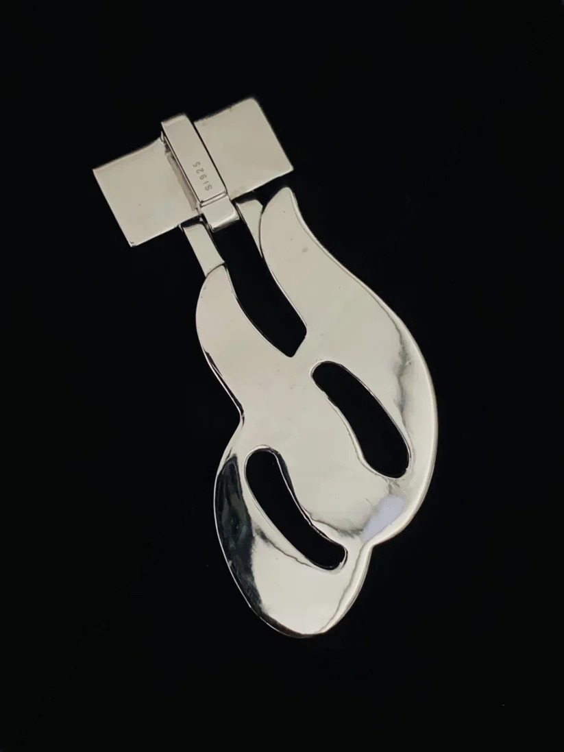 Vintage sterling silver abstract mid-century modern dress clip pendant on black background